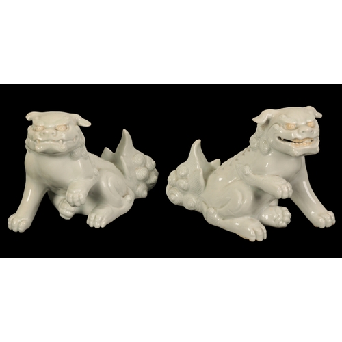 133 - A PAIR OF JAPANESE HIRADO WHITE-GLAZED SHISHI Edo/Meiji, the animals with bushy tails and amusing ex... 