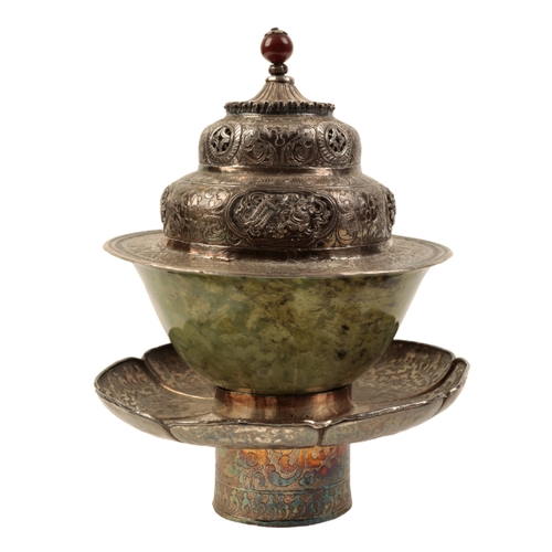 135 - A TIBETAN SILVER 'DHAKA' (TEA BOWL STAND) with engraved and pierced decoration;  with accompanying j... 