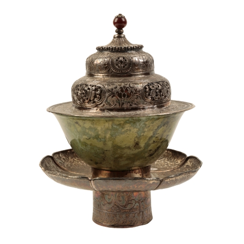 135 - A TIBETAN SILVER 'DHAKA' (TEA BOWL STAND) with engraved and pierced decoration;  with accompanying j... 