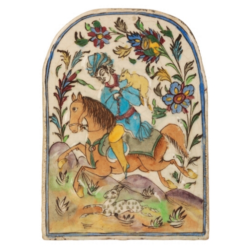 145 - A 'QAJAR' POLYCHROME ARCH-SHAPED PLAQUE probably 19th century, decorated in relief with an equestria... 