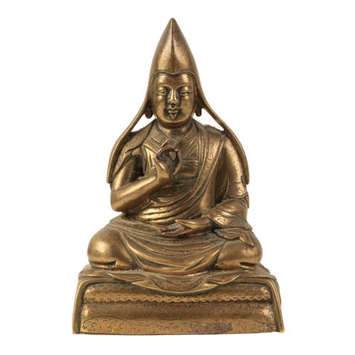 15 - A SINO-TIBETAN BRONZE FIGURE OF A SEATED LAMA Ming or later, wearing a tall hat, 10cm high