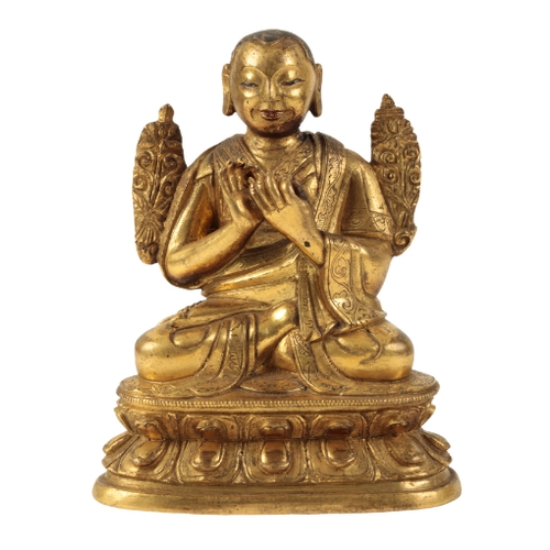 16 - A SMALL SINO-TIBETAN GILT BRONZE OF A BUDDHIST MONK Ming or later, seated in Dhyanasana on a double ... 