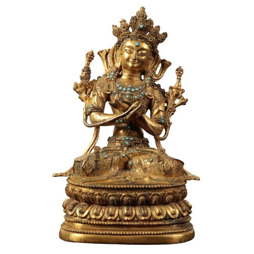 18 - A  SINO-TIBETAN GILT BRONZE FIGURE OF MANJUSHRI Ming or later, seated leaning slightly to the left w... 