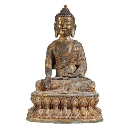 23 - A CHINESE GILT METAL BUDDHA in the Ming style, seated on a double lotus base, 27cm high