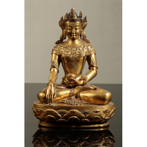 26 - A SINO-TIBETAN GILT BRONZE AMITAYUS, Qing, seated wearing a crown and holding a sacrificial bowl, wi... 