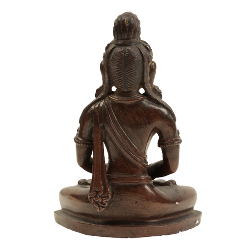 28 - A NEPALESE  BRONZE FIGURE OF AMITAYUS Qing or later, sitting cross legged on a shaped base, 9.5cm hi... 