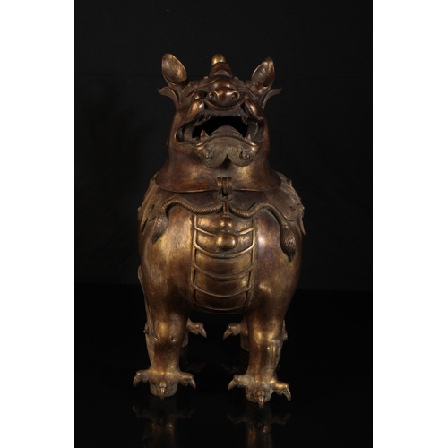 32 - A CHINESE GILT BRONZE LION INCENSE-BURNER with a detachable head, the mane and upright tail with fin... 