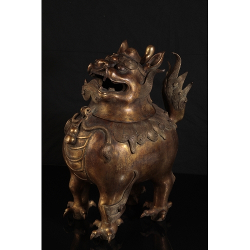 32 - A CHINESE GILT BRONZE LION INCENSE-BURNER with a detachable head, the mane and upright tail with fin... 