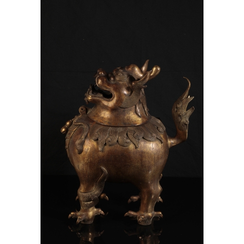 32 - A CHINESE GILT BRONZE LION INCENSE-BURNER with a detachable head, the mane and upright tail with fin... 