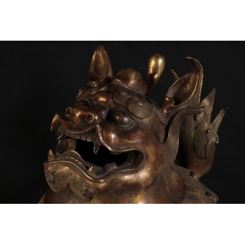 32 - A CHINESE GILT BRONZE LION INCENSE-BURNER with a detachable head, the mane and upright tail with fin... 