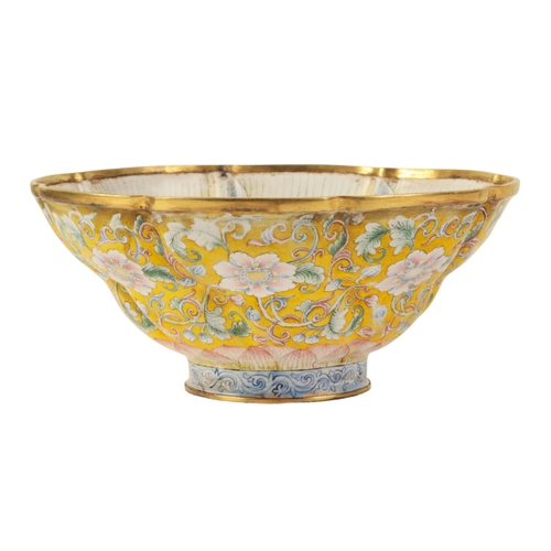 40 - A CHINESE FAMILLE ROSE ENAMEL BOWL of moulded octofoil form, painted with flowering tendrils on a ye... 