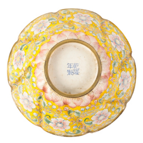 40 - A CHINESE FAMILLE ROSE ENAMEL BOWL of moulded octofoil form, painted with flowering tendrils on a ye... 