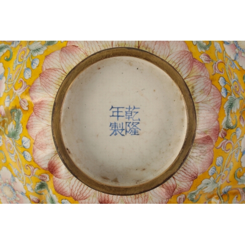 40 - A CHINESE FAMILLE ROSE ENAMEL BOWL of moulded octofoil form, painted with flowering tendrils on a ye... 