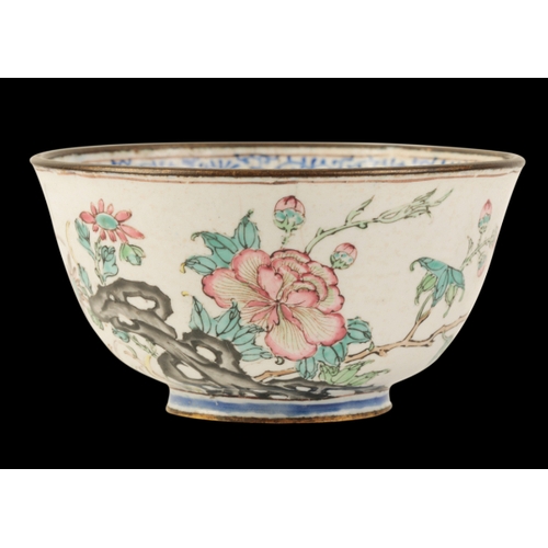 41 - A CHINESE CANTON ENAMEL FAMILLE ROSE WINE CUP Qianlong, delicately painted with flowers and rockwork... 