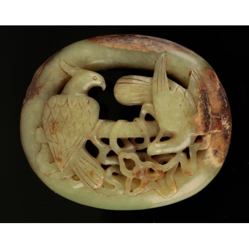 47 - A CHINESE YELLOW JADE OVAL BELT BUCKLE Ming or later, carved and pierced with an eagle perched on a ... 