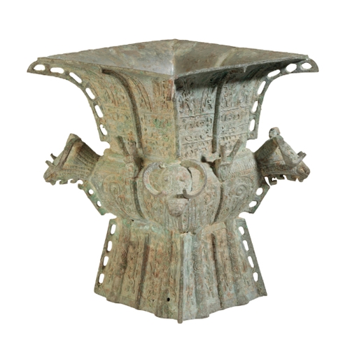 5 - A CHINESE 'ARCHAISTIC' BRONZE VESSEL with pierced flanges and four rams-head handles, 20cm high x 17... 