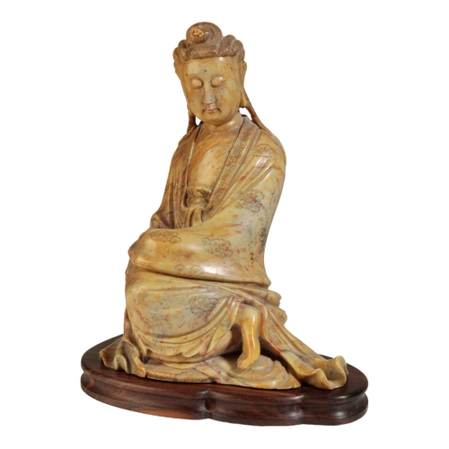 58 - A LARGE CHINESE SOAPSTONE GUANYIN probably early Qing, her finely carved hair piled into a chignon a... 