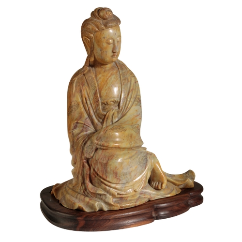 58 - A LARGE CHINESE SOAPSTONE GUANYIN probably early Qing, her finely carved hair piled into a chignon a... 