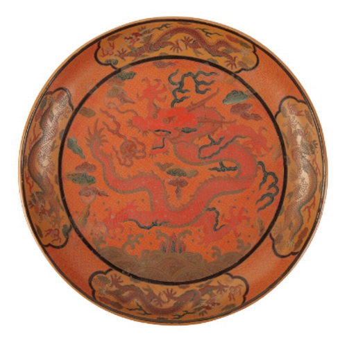 62 - A CHINESE LACQUER DISH decorated in polychrome and incised with a central five-clawed dragon chasing... 