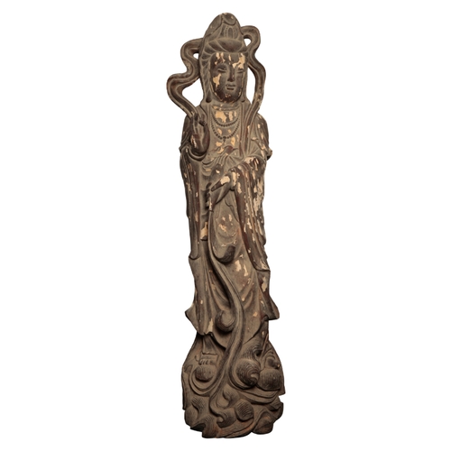 64 - A MONUMENTAL CHINESE LACQUERED WOOD FIGURE OF GUANYIN Qing or later, standing on a wave-scroll base,... 