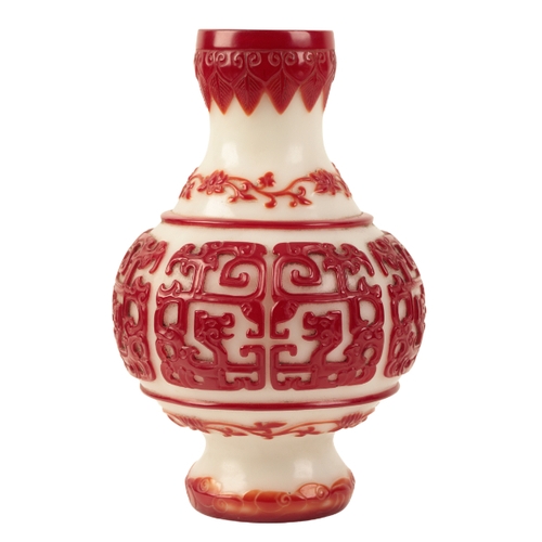 68 - A 'BEIJING' WHITE AND RED OVERLAY GLASS VASE probably Qing, decorated with archaistic dragon panels ... 