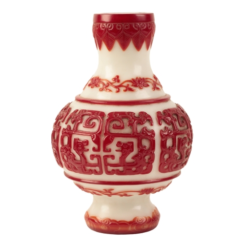 68 - A 'BEIJING' WHITE AND RED OVERLAY GLASS VASE probably Qing, decorated with archaistic dragon panels ... 