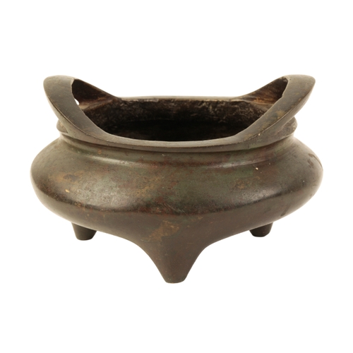 7 - A CHINESE BRONZE TWO-HANDLED TRIPOD CENSER the base with a Xuande four-character mark, the surface w... 