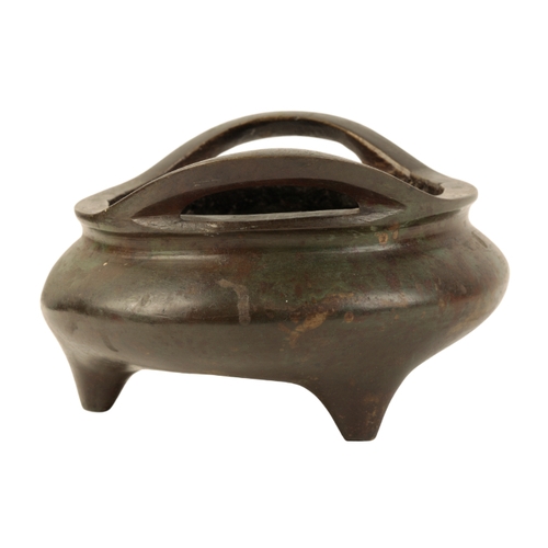 7 - A CHINESE BRONZE TWO-HANDLED TRIPOD CENSER the base with a Xuande four-character mark, the surface w... 