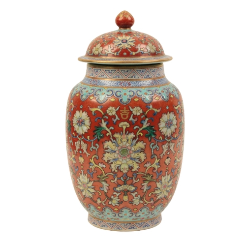 94 - A CHINESE RUBY-GROUND LIDDED JAR enamelled in polychrome with scrolling lotus and fish within formal... 