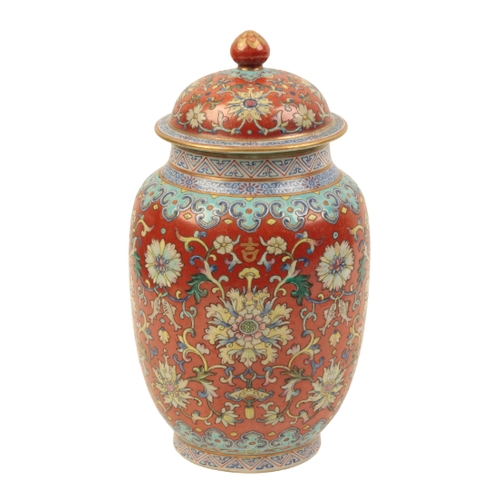 94 - A CHINESE RUBY-GROUND LIDDED JAR enamelled in polychrome with scrolling lotus and fish within formal... 