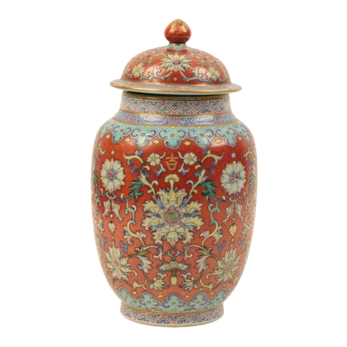 94 - A CHINESE RUBY-GROUND LIDDED JAR enamelled in polychrome with scrolling lotus and fish within formal... 