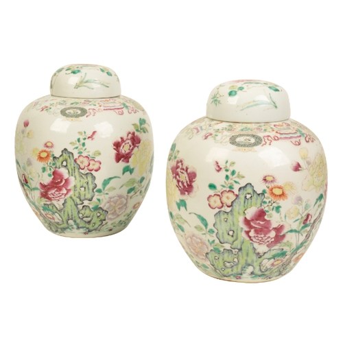 99 - A PAIR OF CHINESE FAMILLE ROSE JARS AND COVERS Qing, enamelled in polychrome with flowers issuing fr... 