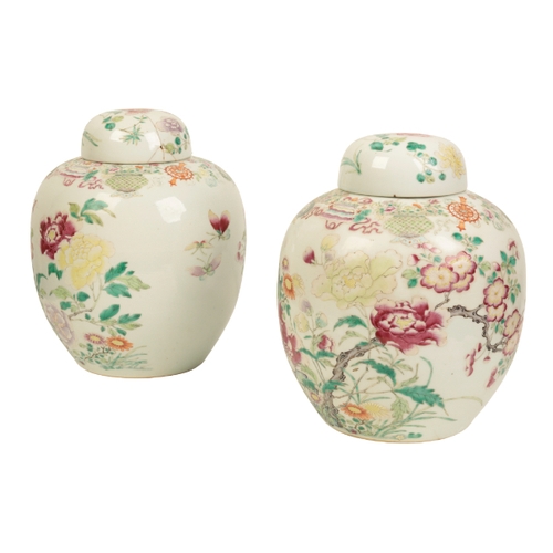 99 - A PAIR OF CHINESE FAMILLE ROSE JARS AND COVERS Qing, enamelled in polychrome with flowers issuing fr... 