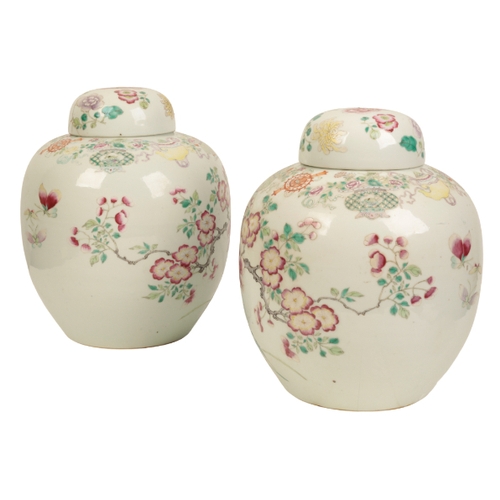 99 - A PAIR OF CHINESE FAMILLE ROSE JARS AND COVERS Qing, enamelled in polychrome with flowers issuing fr... 