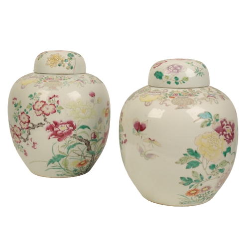 99 - A PAIR OF CHINESE FAMILLE ROSE JARS AND COVERS Qing, enamelled in polychrome with flowers issuing fr... 