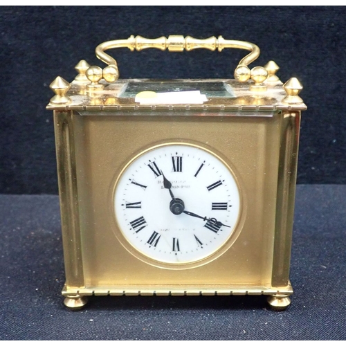 212 - AN EDWARDIAN BRASS CARRIAGE TIMEPIECE RETAILED BY HARRODS 8.5cm high, with key (cracked to dial) and... 