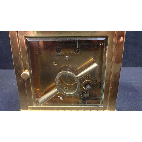 212 - AN EDWARDIAN BRASS CARRIAGE TIMEPIECE RETAILED BY HARRODS 8.5cm high, with key (cracked to dial) and... 