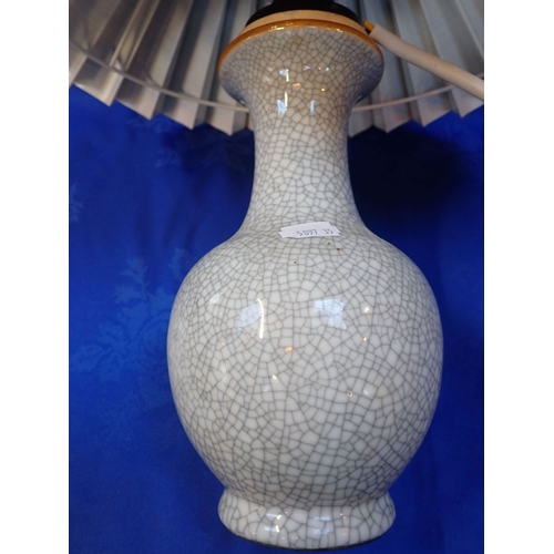 323 - A CHINESE CRACKLEWARE PORCELAIN BULBOUS VASE with grey glaze, 21.5cm high (repaired to rim), with ca... 