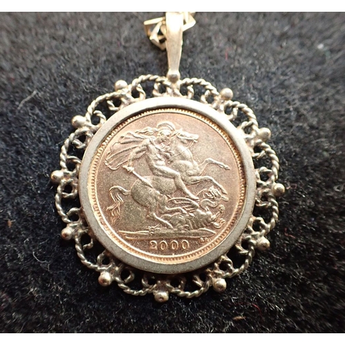 427 - A HALF SOVEREIGN DATED 2000 mounted as a pendant, attached to 9ct gold chain