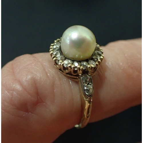 459 - A GOLD COLOURED METAL, DIAMOND AND PEARL CABOCHON RING the central pearl surrounded by approx. twent... 