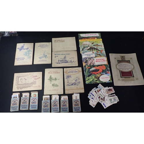 561 - A COLLECTION OF CIGARETTE CARDS in albums and in Players cigarette packets