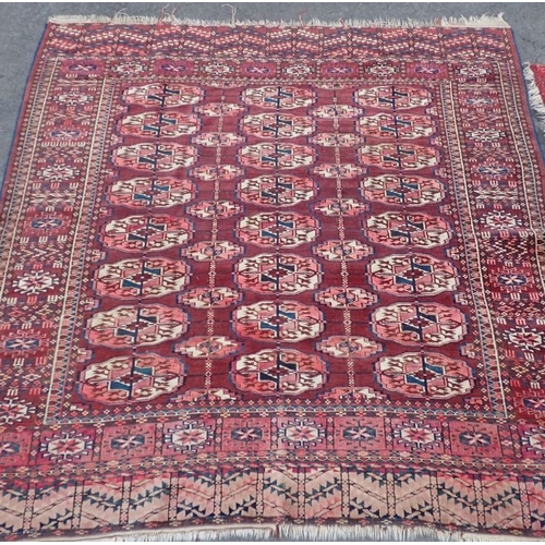 666 - AN ANTIQUE TEKKE TURKMEN RUG woven in off white and blue with three rows of eight guls on a cochinea... 