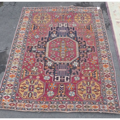 667 - AN ANATOLIAN RUG woven in orange, blue and yellow with cruciform medallion and filler motifs on a fa... 