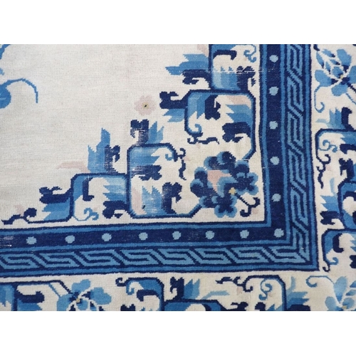 669 - CHINESE PEKING RUG BLUE ON CREAM GROUND worn and marked, 194 x 277cm