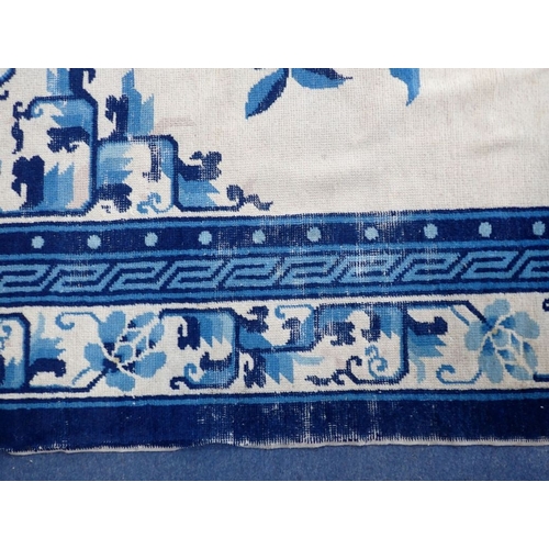 669 - CHINESE PEKING RUG BLUE ON CREAM GROUND worn and marked, 194 x 277cm