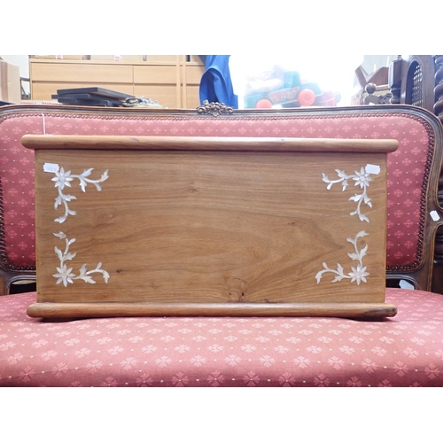 689 - A SMALL TEAK TRUNK WITH MOTHER-OF-PEARL INLAY 61cm wide