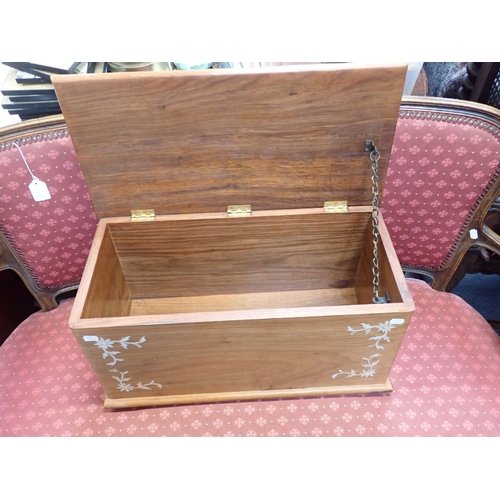 689 - A SMALL TEAK TRUNK WITH MOTHER-OF-PEARL INLAY 61cm wide