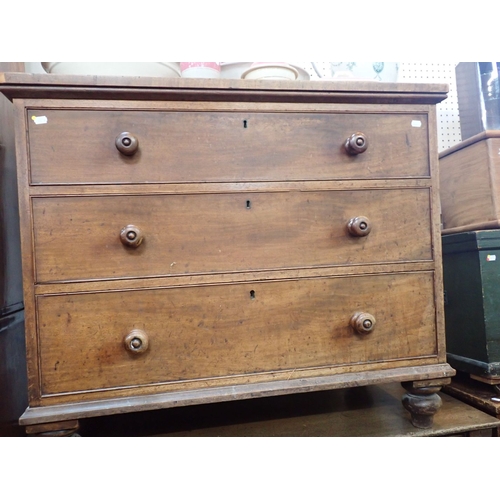 693 - A 19TH CENTURY MAHOGANY CHEST OF THREE DRAWERS with turned feet and knobs 102cm wide (some veneer lo... 