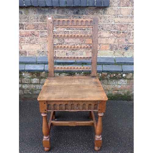 744 - A SET OF FOUR OAK DINING CHAIRS with flat boarded seats and decorated backs in the 17th century styl... 