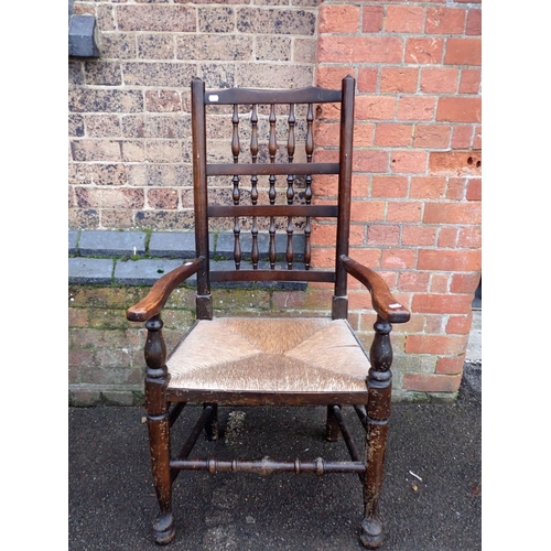 754 - AN ASH LADDERBACK ARMCHAIR with rush seat 64cm wide, and a reproduction Lancashire type armchair (2)